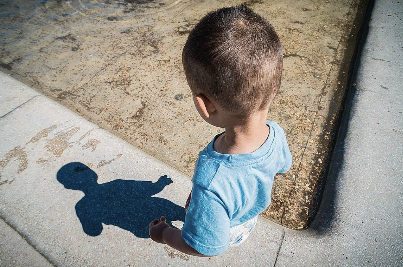 image of a boy looking at his shadow